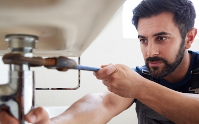 Plumber working on sink